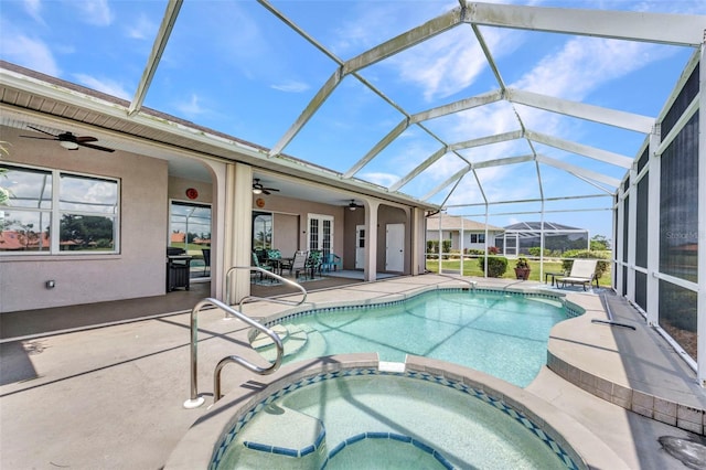 12951 SW Kingsway Cir, Lake Suzy, FL 34269 - view of pool featuring a ceiling fan, a patio area, a pool with connected hot tub, and glass enclosure