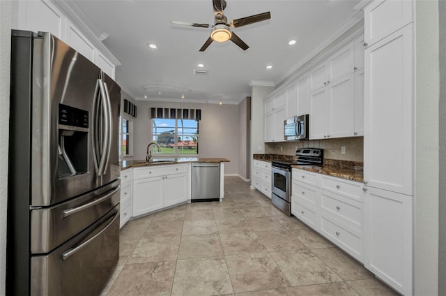 12951 SW Kingsway Cir, Lake Suzy, FL 34269 - kitchen with appliances with stainless steel finishes, ornamental molding, a sink, a peninsula, and white cabinets