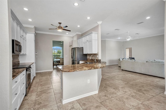 12951 SW Kingsway Cir, Lake Suzy, FL 34269 - kitchen with a ceiling fan, appliances with stainless steel finishes, a sink, dark stone countertops, and recessed lighting