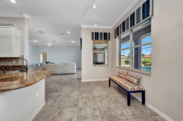 12951 SW Kingsway Cir, Lake Suzy, FL 34269 - hallway with a sink, ornamental molding, baseboards, recessed lighting, and light tile patterned flooring