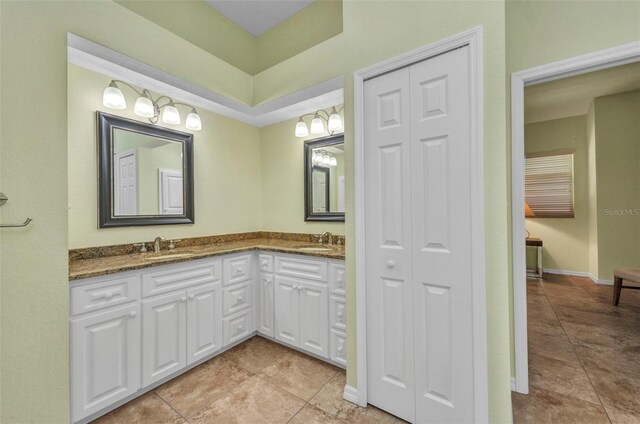 12951 SW Kingsway Cir, Lake Suzy, FL 34269 - full bathroom with tile patterned floors, double vanity, and a closet