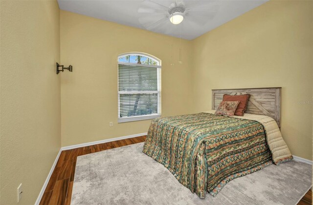 12951 SW Kingsway Cir, Lake Suzy, FL 34269 - bedroom with baseboards, wood finished floors, and a ceiling fan