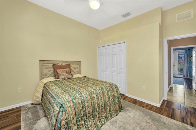 12951 SW Kingsway Cir, Lake Suzy, FL 34269 - bedroom with baseboards, wood finished floors, a closet, and a towering ceiling