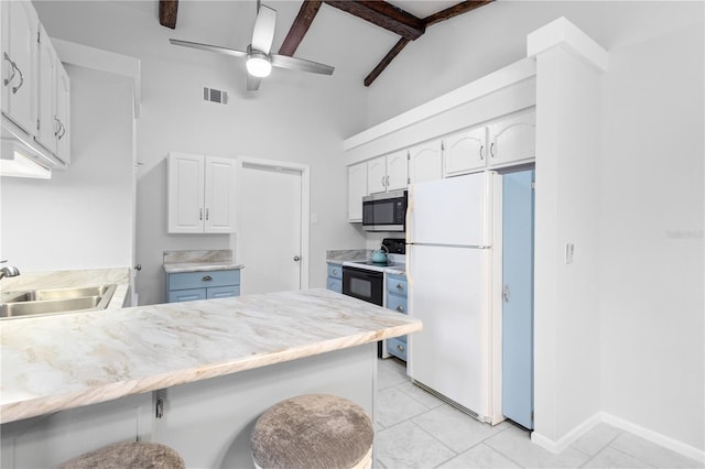 5301 Linksman Pl, North Port, FL 34287 - kitchen featuring freestanding refrigerator, stainless steel microwave, a sink, a peninsula, and electric range oven
