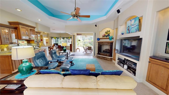 8596 SW Riverside Dr, Arcadia, FL 34269 - living area with ceiling fan, a raised ceiling, a high end fireplace, recessed lighting, and light tile patterned flooring