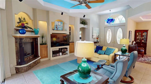 8596 SW Riverside Dr, Arcadia, FL 34269 - living area with ceiling fan, light tile patterned floors, a high ceiling, a fireplace, and arched walkways