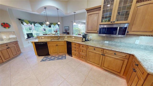 8596 SW Riverside Dr, Arcadia, FL 34269 - kitchen featuring dishwasher, stainless steel microwave, a peninsula, a sink, and light stone counters