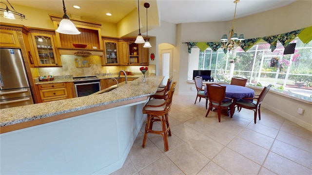 8596 SW Riverside Dr, Arcadia, FL 34269 - kitchen featuring appliances with stainless steel finishes, brown cabinetry, decorative backsplash, and recessed lighting