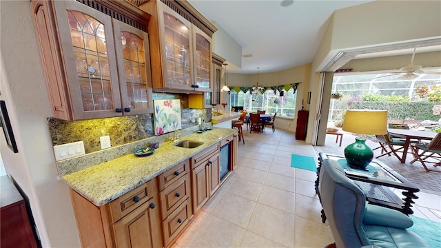 8596 SW Riverside Dr, Arcadia, FL 34269 - kitchen with tasteful backsplash, a sink, light stone counters, glass insert cabinets, and pendant lighting