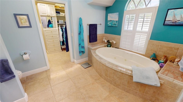 8596 SW Riverside Dr, Arcadia, FL 34269 - full bath with tile patterned floors, a tub with jets, and a walk in closet