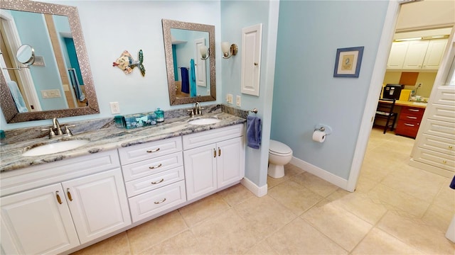 8596 SW Riverside Dr, Arcadia, FL 34269 - full bathroom with tile patterned flooring, toilet, double vanity, and baseboards