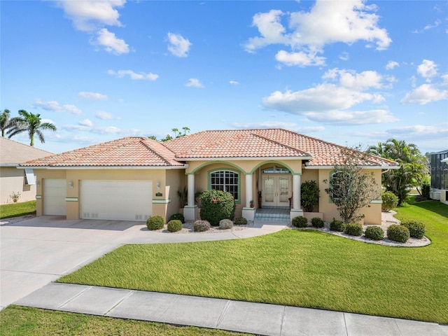 mediterranean / spanish-style home with french doors, stucco siding, a garage, a front yard, and concrete driveway
