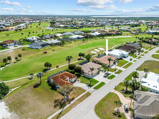 aerial view of residential area with a golf course and a nearby body of water