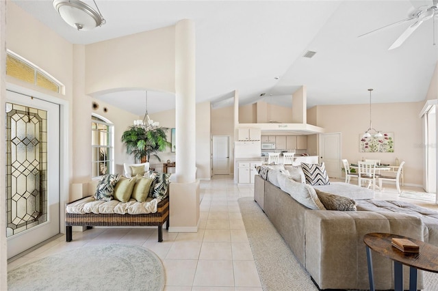 living room with light tile patterned floors, a chandelier, high vaulted ceiling, and plenty of natural light