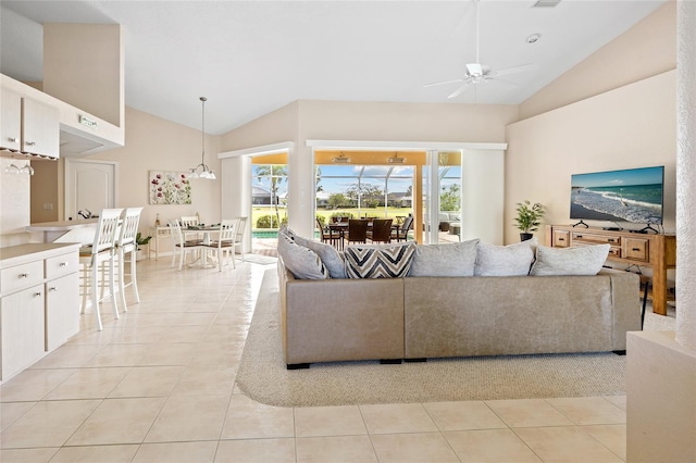 living room featuring a ceiling fan, high vaulted ceiling, and light tile patterned floors