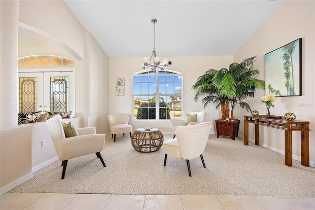 living area featuring carpet, a chandelier, baseboards, tile patterned floors, and high vaulted ceiling