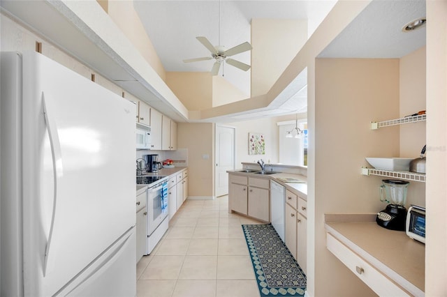 kitchen featuring white appliances, ceiling fan, a sink, light tile patterned floors, and light countertops