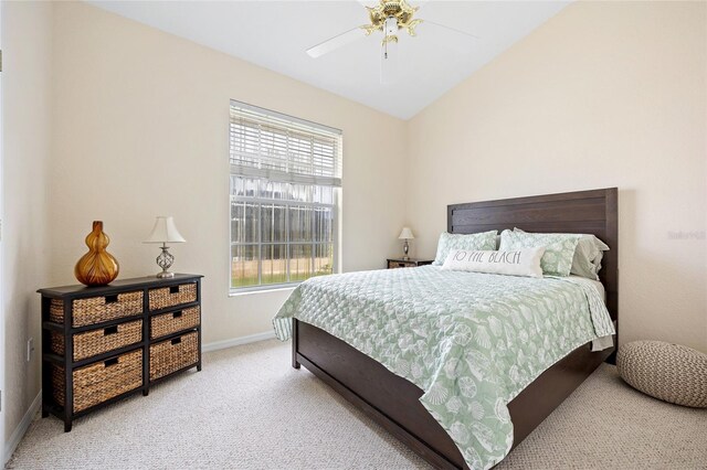 bedroom featuring light colored carpet, baseboards, and a ceiling fan