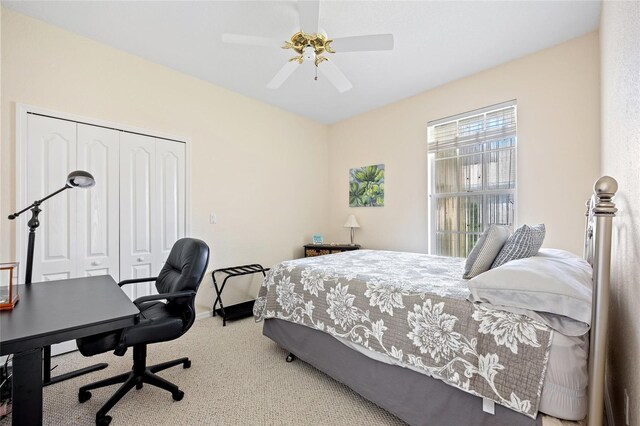 bedroom featuring carpet, a closet, a desk, ceiling fan, and baseboards
