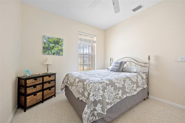 carpeted bedroom featuring baseboards and a ceiling fan
