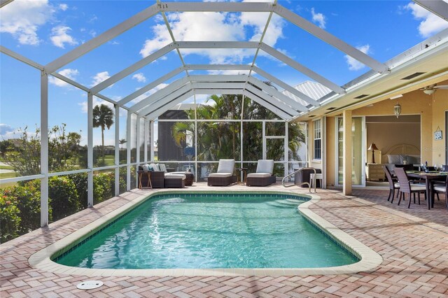 swimming pool featuring a patio, an outdoor hangout area, a lanai, and ceiling fan