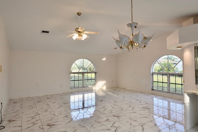 unfurnished room featuring light marble finish flooring, high vaulted ceiling, a chandelier, and ceiling fan