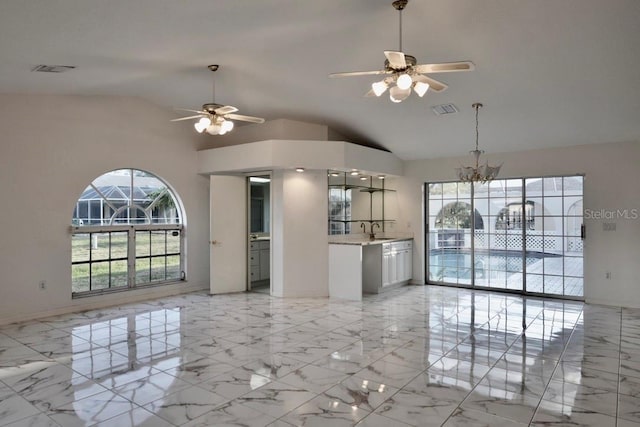 unfurnished living room with a ceiling fan, a sink, a chandelier, high vaulted ceiling, and light marble finish flooring