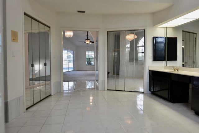 bathroom featuring a chandelier and vanity