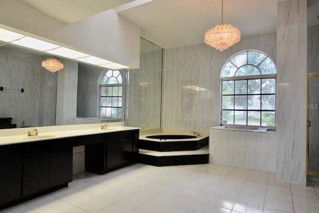 full bath with a garden tub, double vanity, and a chandelier
