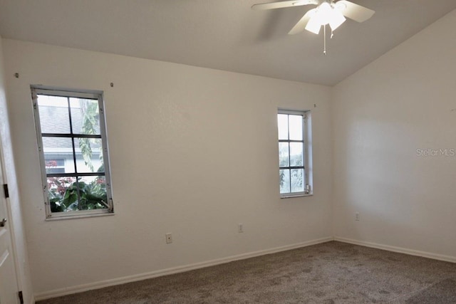 carpeted empty room featuring healthy amount of natural light, a ceiling fan, baseboards, and lofted ceiling