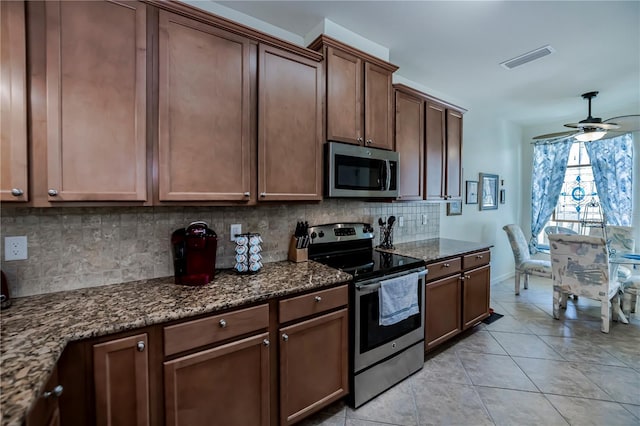 15050 Sandpiper Preserve Blvd Unit 101, Fort Myers, FL 33919 - kitchen with dark stone counters, stainless steel appliances, visible vents, ceiling fan, and tasteful backsplash