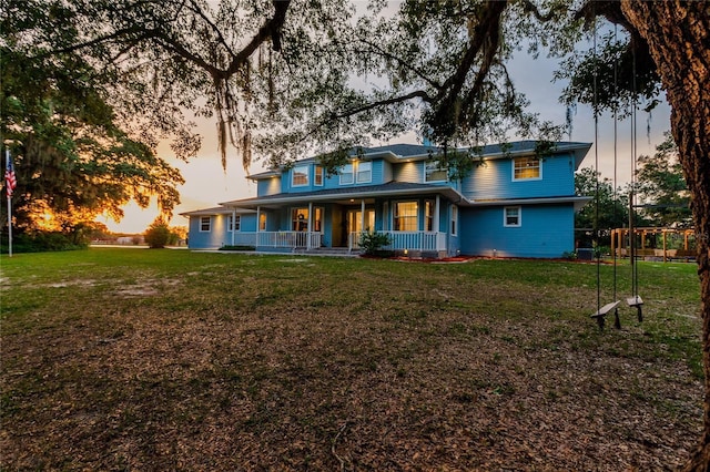 7192 SW Albritton St, Arcadia, FL 34266 - back of property at dusk with a porch and a yard