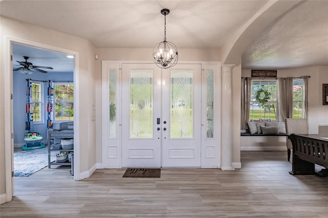 7192 SW Albritton St, Arcadia, FL 34266 - entryway featuring baseboards, wood finished floors, a chandelier, and plenty of natural light