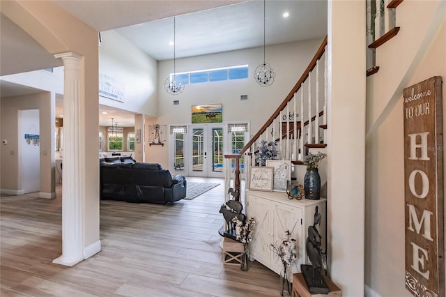 7192 SW Albritton St, Arcadia, FL 34266 - foyer entrance featuring ornate columns, french doors, wood finished floors, a chandelier, and baseboards
