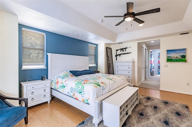 7192 SW Albritton St, Arcadia, FL 34266 - bedroom with light wood-style floors, a ceiling fan, baseboards, recessed lighting, and a raised ceiling