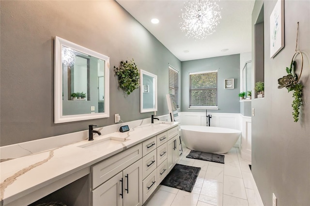 7192 SW Albritton St, Arcadia, FL 34266 - bathroom featuring double vanity, a freestanding bath, wainscoting, and a chandelier