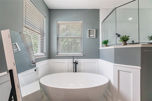 7192 SW Albritton St, Arcadia, FL 34266 - full bathroom with a soaking tub, a decorative wall, and wainscoting