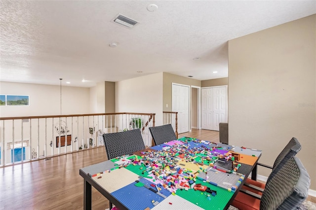 7192 SW Albritton St, Arcadia, FL 34266 - dining space with wood finished floors, a textured ceiling, and baseboards
