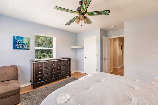 7192 SW Albritton St, Arcadia, FL 34266 - bedroom with wood finished floors, baseboards, and a ceiling fan