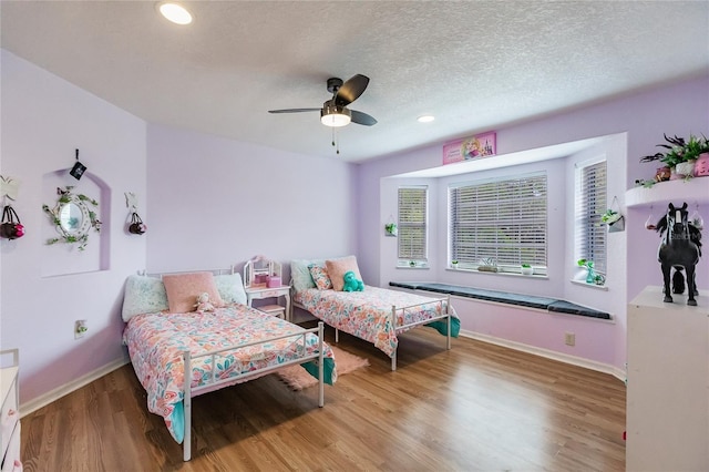 7192 SW Albritton St, Arcadia, FL 34266 - bedroom featuring baseboards, wood finished floors, recessed lighting, a ceiling fan, and a textured ceiling