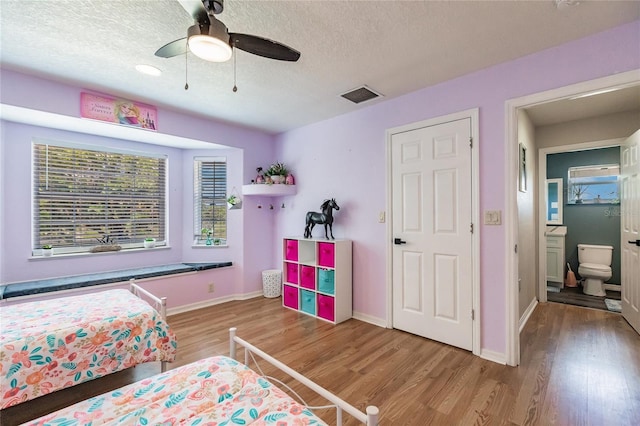 7192 SW Albritton St, Arcadia, FL 34266 - bedroom with wood finished floors, baseboards, a textured ceiling, and ceiling fan