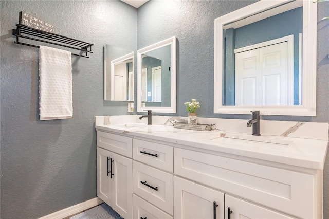 7192 SW Albritton St, Arcadia, FL 34266 - full bath featuring double vanity, a textured wall, and baseboards