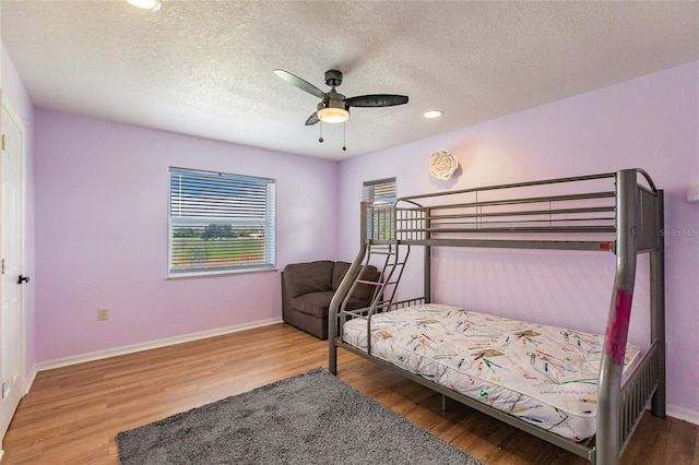 7192 SW Albritton St, Arcadia, FL 34266 - bedroom featuring wood finished floors, baseboards, a textured ceiling, a ceiling fan, and recessed lighting