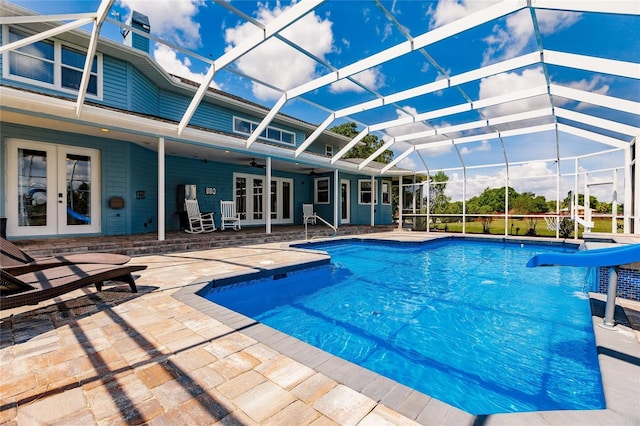 7192 SW Albritton St, Arcadia, FL 34266 - outdoor pool with french doors, a water slide, a patio, a ceiling fan, and a lanai