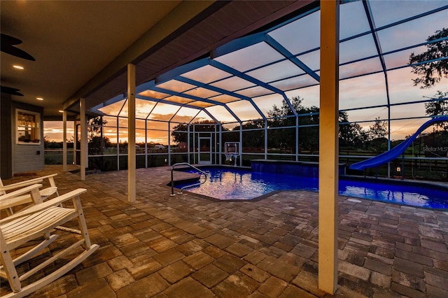 7192 SW Albritton St, Arcadia, FL 34266 - swimming pool with a water slide, a patio area, a ceiling fan, and glass enclosure