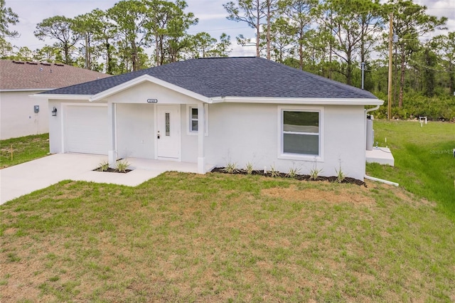 27438 Corinthian Dr, Punta Gorda, FL 33955 - ranch-style house featuring a shingled roof, a front lawn, driveway, a garage, and stucco siding