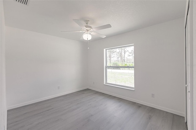 27438 Corinthian Dr, Punta Gorda, FL 33955 - spare room with wood finished floors, baseboards, and a ceiling fan