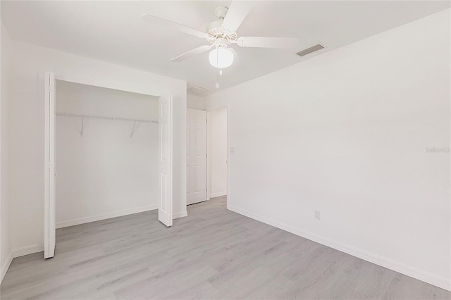 27438 Corinthian Dr, Punta Gorda, FL 33955 - unfurnished bedroom with wood finished floors, baseboards, a closet, and ceiling fan