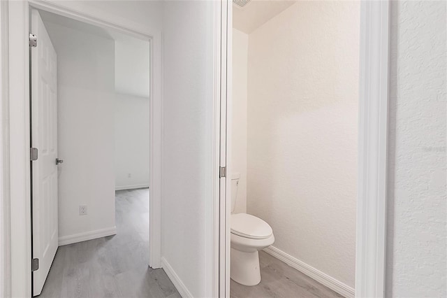 27438 Corinthian Dr, Punta Gorda, FL 33955 - bathroom with wood finished floors, toilet, and baseboards