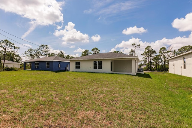 27438 Corinthian Dr, Punta Gorda, FL 33955 - back of property with a yard and stucco siding